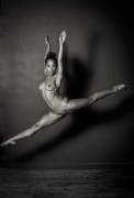 A gorgeous flexible gymnast in flight