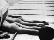 The wife of photographer Jacques-Henri Lartigue, Bibi, and Denise Grey sunbathing on the Dahu II in July 1926 near Royan, France