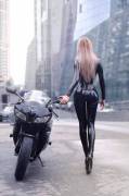 Girl in Latex and heels beside bike (Anyone know who this is?)