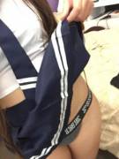 Schoolgirl lifing her skirt after class