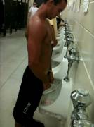 Shirtless at the urinal