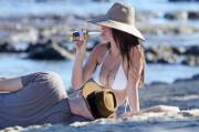 Emily Ratajkowski drinking a beer on the beach