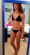 Girl in black bikini wears glasses