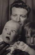 African American holding baby up in family photograph leading to crazy expression, caption it!