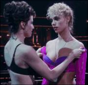Gina Gershon pulling down Elizabeth Berkley's shirt in a very Dominant way (from Showgirls)