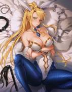 Larturia laying in bed with some toys