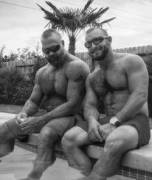 Two muscle men by the pool