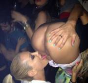 Licking her friend at the club