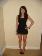 Brunette cutie posing in tight black dress