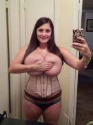 Younger wife stuffed in a tight corset covers her Nipples to keep the picture she's about to send her boss appropriate and classy