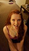 Splattered redhead on her knees