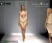 Sexy model's amazing boobs break free from her outfit on the runway [gif]