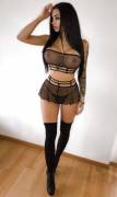 Bimbo beauty in sexy black lingerie and thigh high boots.