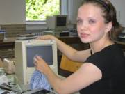 Cute teen cleaning a vintage Mac