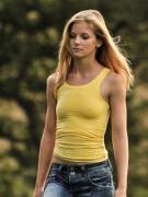 blonde pokies in a yellow top and tight jeans