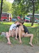 2 barefoot girls with clothes undone kissing in public