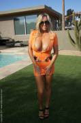 Busty Blonde Mom in a sexy orange dress