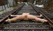 Bound spread eagle to railroad tracks