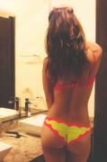 Red and yellow scrunchie bikini in hotel bathroom