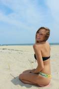 Happy girl sitting in the dunes