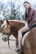 Riding her horse