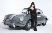 Hitomi Tanaka with silver, old-school European car. (Sexy homage to James Bond films)