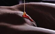 Honey slowly pouring on her pussy