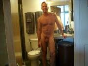 Handsome daddy with glasses in front of bathroom mirror