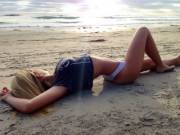 Laying in the sand.