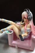 Super Sonico in a pink chair covered in cum