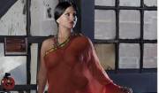 Sunny Leone looks ravishing in a red bridal saree without blouse.