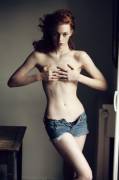 Topless ginger in jeans shorts