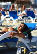 Busty babe getting tan at the beach