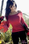 Denise Milani filling out a sweater