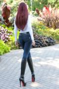 Redhead, jean and black boots from rear view